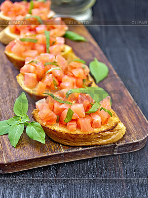 Bruschetta with tomato and basil on table | High resolution stock photo |ID 6810334