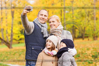 Happy family with camera in autumn park | High resolution stock photo |ID 4546357