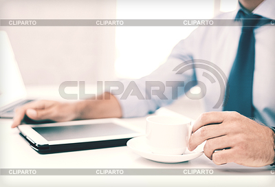 Businessman with tablet pc and coffee in office | High resolution stock photo |ID 4597897