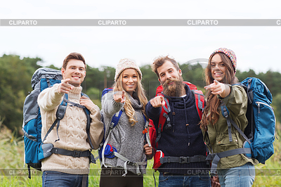 Smiling hikers with backpacks pointing finger | High resolution stock photo |ID 4599619
