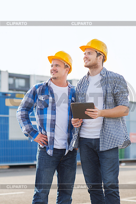 Smiling builders with tablet pc outdoors | High resolution stock photo |ID 4599688