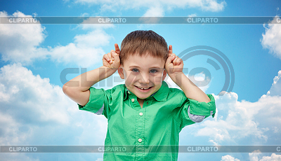 Happy little boy having fun and making horns | High resolution stock photo |ID 5660828