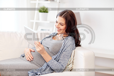 Happy pregnant woman with tablet pc at home | High resolution stock photo |ID 5769344