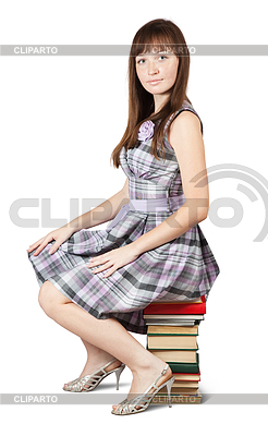 Student sits on pile of books | High resolution stock photo |ID 4005237